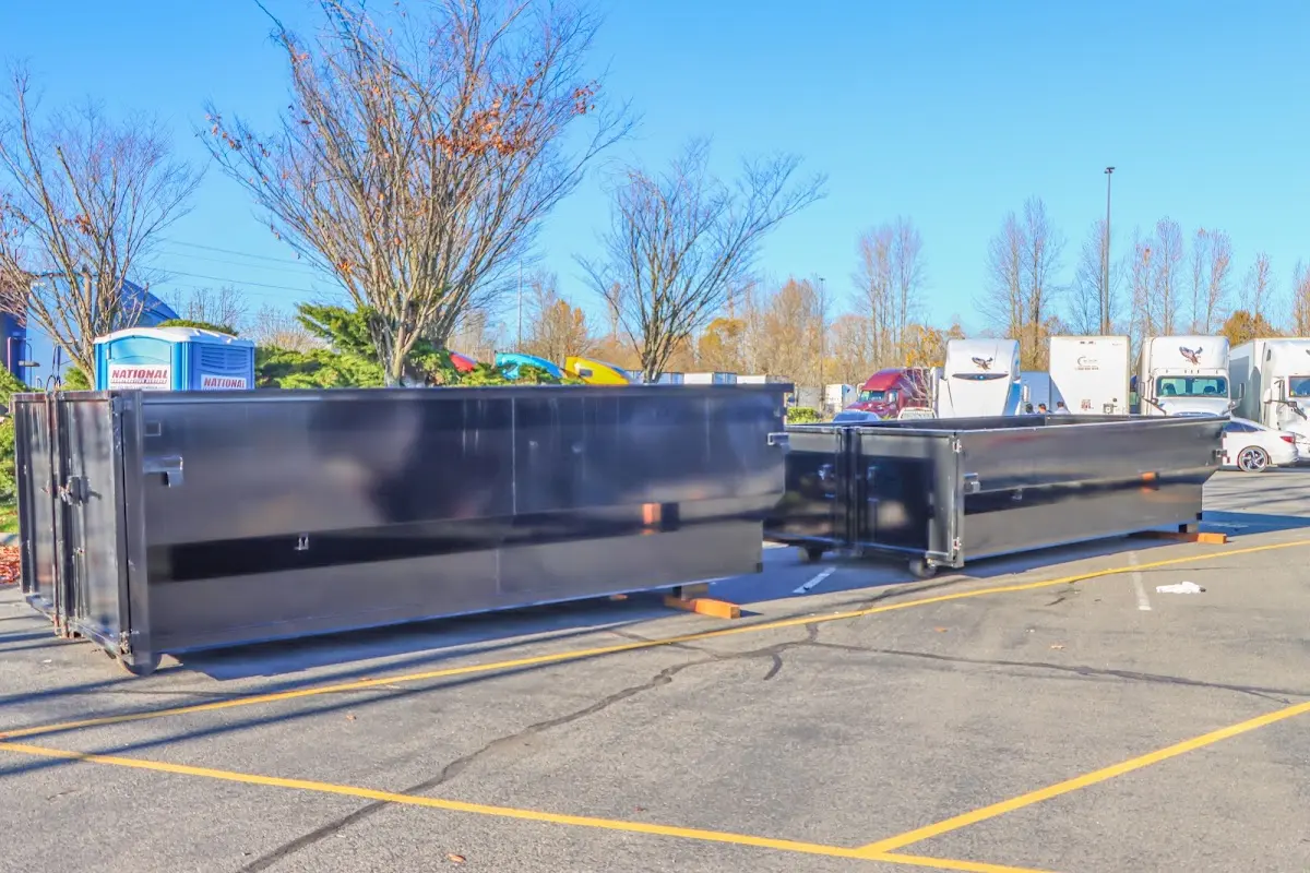 Professional dumpster rental service with roll-off container on residential driveway in Leisure City